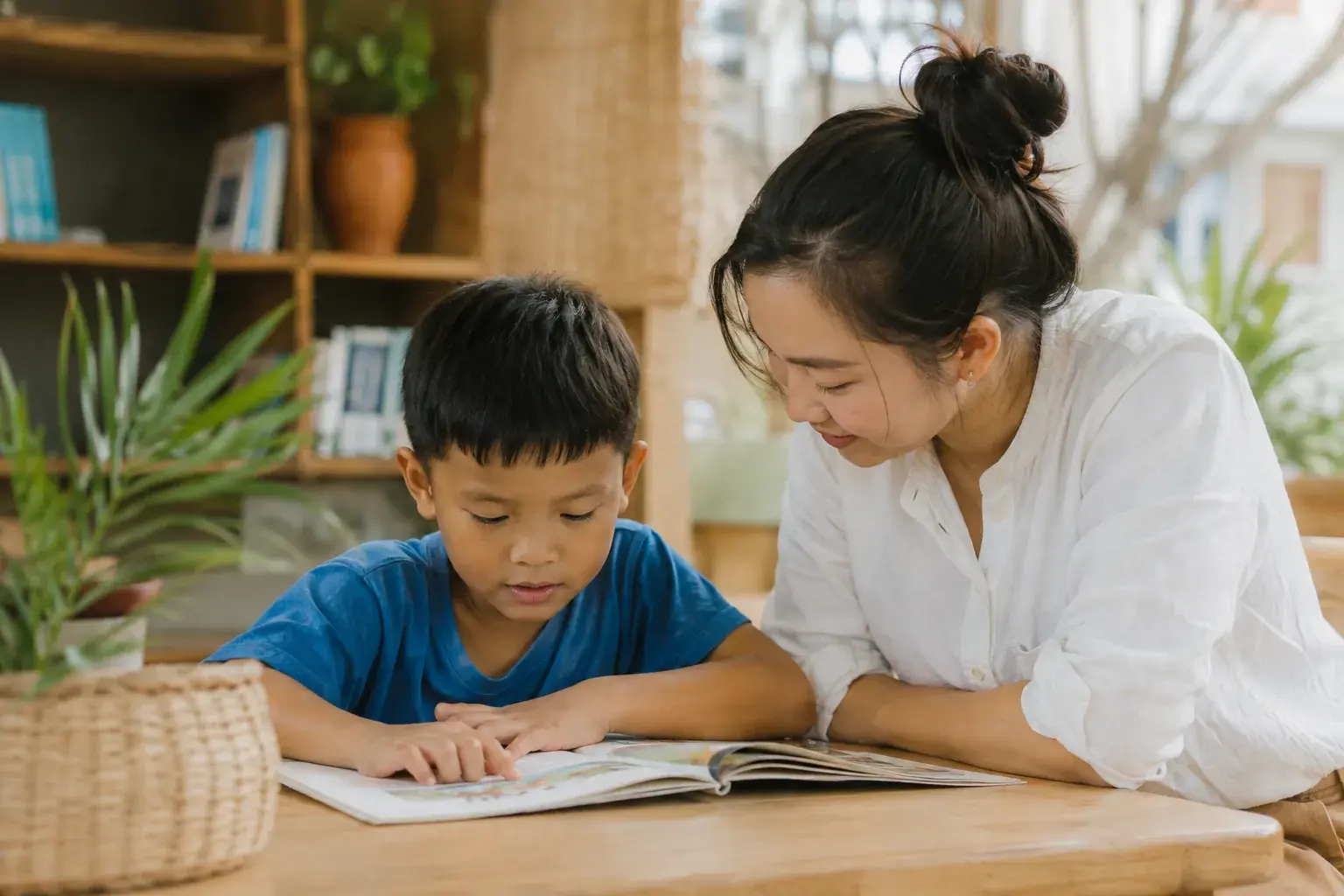 A volunteer mentor reading with a child